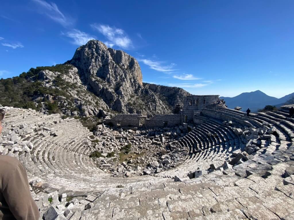 Ancient amphitheater ruins with a rocky mountain backdrop at Termessos, Turkey