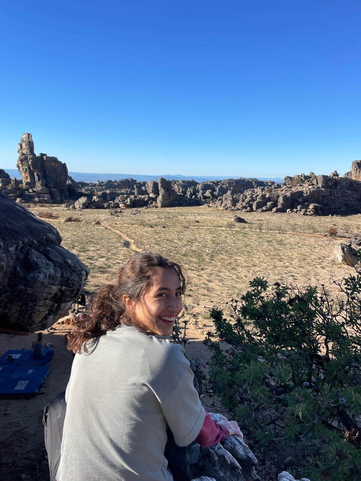 Woman smiling at rocky desert landscape viewpoint