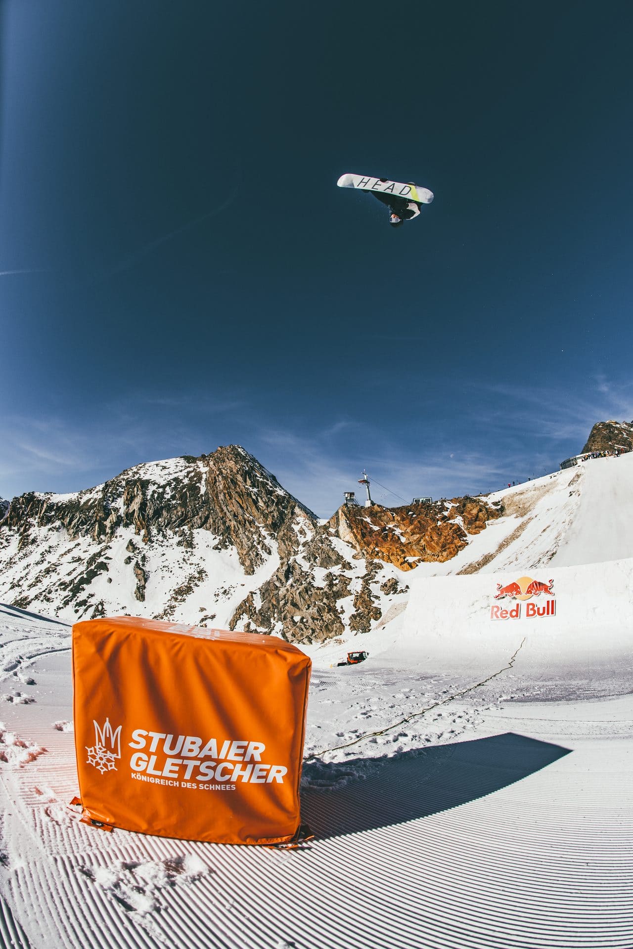 Snowboarder in the air above the Stubai Glacier park in Austria